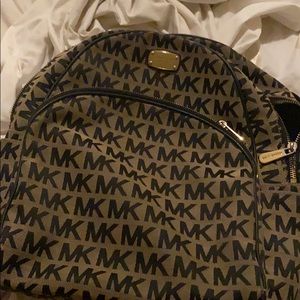 A Micheal Kors book bag. Very small and cute